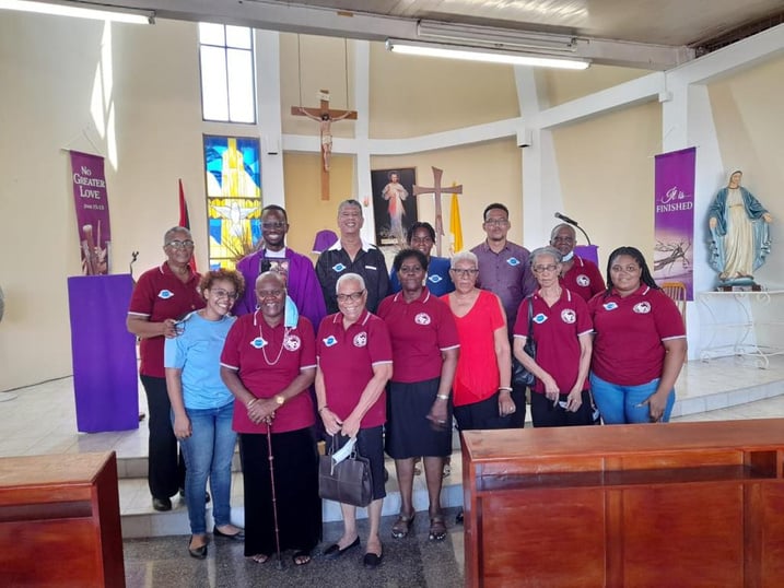 Young Vincentians in red shirts gathered inside a church