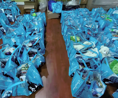 Rows of blue hamper bags packed for distribution