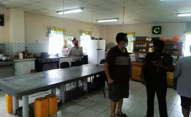 Interior dining area of the San Fernando home with volunteers
